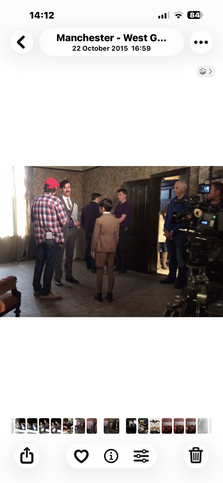 Actors and crew working on a professional period film set